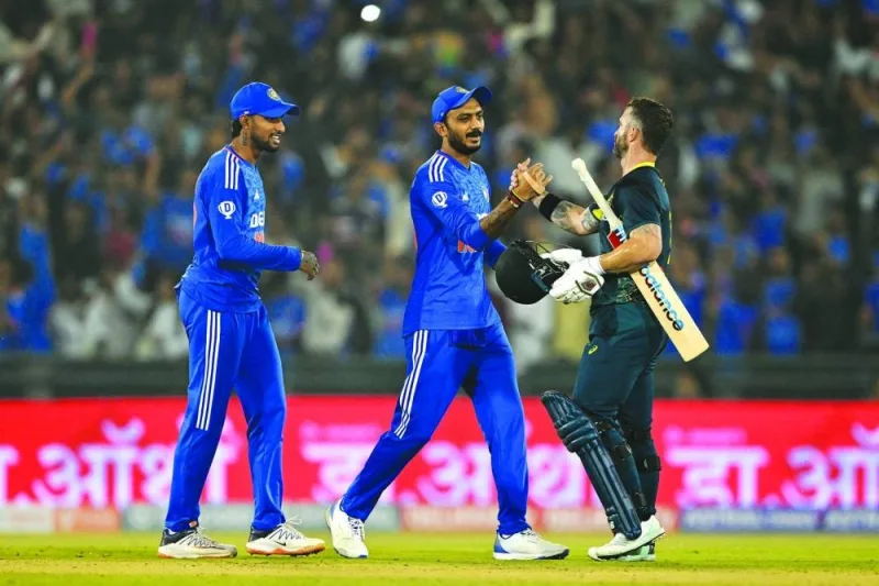 
Australia’s captain Matthew Wade (right) greets India’s Washington Sundar and Axar Patel at the end of the fourth T20I at the Shaheed Veer Narayan Singh International Cricket Stadium in Raipur yesterday. (AFP) 
