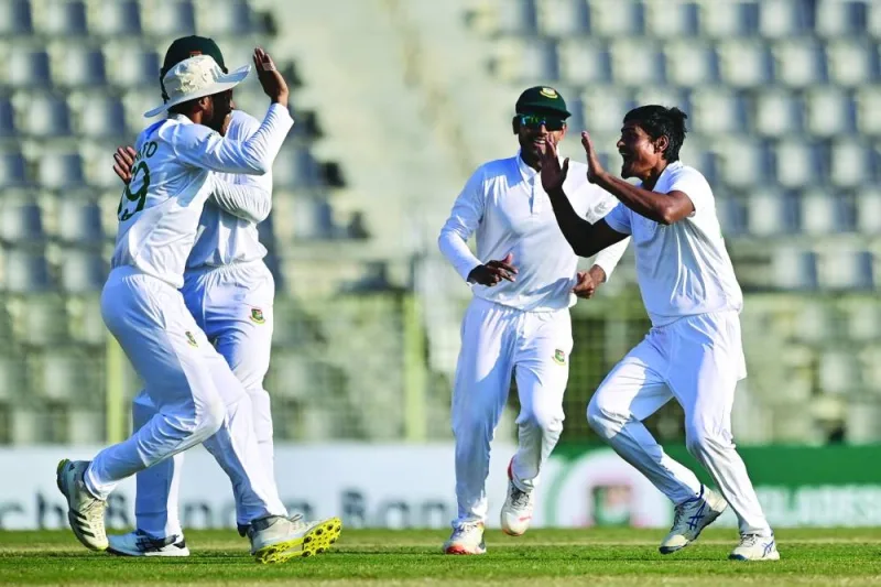 
Bangladesh’s Taijul Islam (right) celebrates with teammates after the dismissal of New Zealand’s Tom Blundell during the fourth day of the first Test at the Sylhet International Cricket Stadium in Sylhet yesterday. (AFP) 