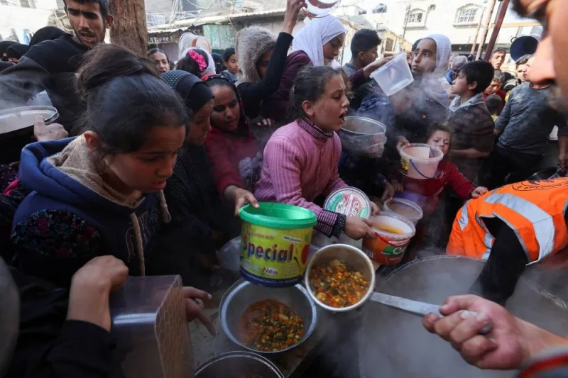 Palestinians gather to get their share of charity food offered by volunteers, amid food shortages, in Rafah, in the southern Gaza Strip, on Saturday. REUTERS