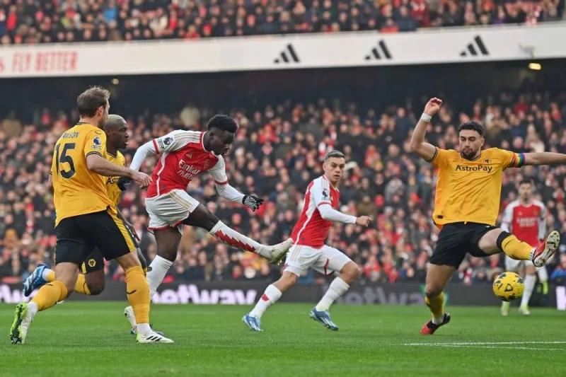 
Arsenal’s Bukayo Saka (centre) scores during the Premier League match against Wolverhampton Wanderers in London yesterday. (AFP)  