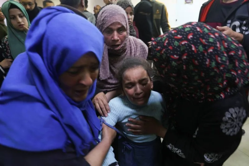 People react as they rush to the hospital following an Israeli strike at Nasser hospital in Khan Younis in the southern Gaza Strip, on Sunday. REUTERS