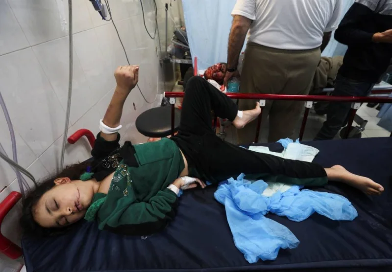 A Palestinian child lies on a bed after being rushed to the hospital following an Israeli strike, at Nasser hospital in Khan Younis in the southern Gaza Strip, on Sunday. REUTERS