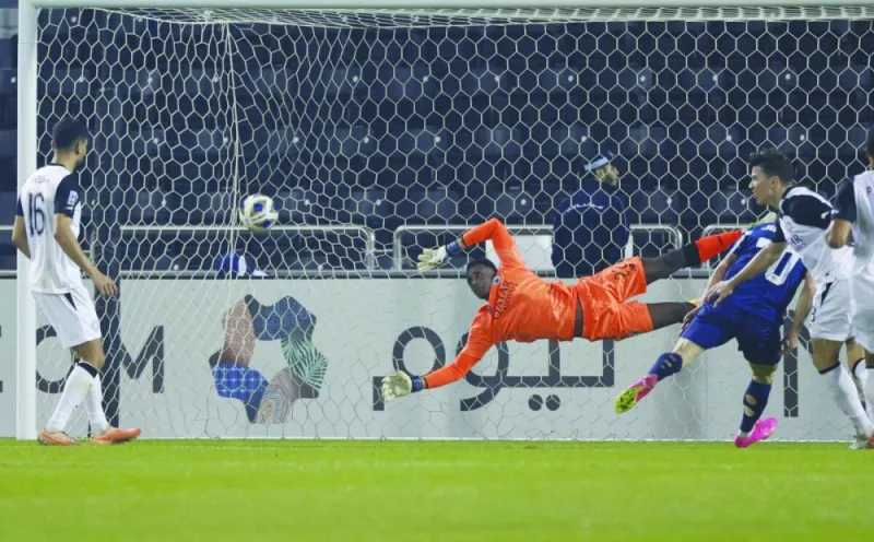 
Al Sadd goalkeeper Meshaal Barsham fails to save a goal-bound shot. 