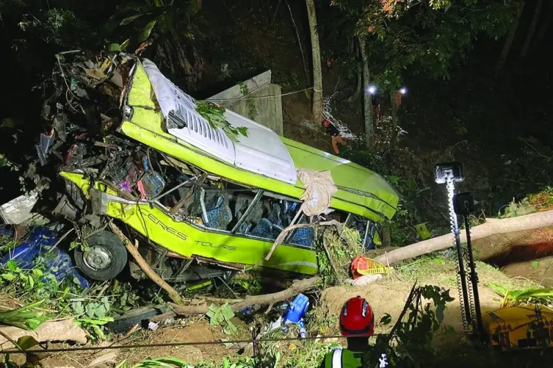 This handout photo taken on December 5, 2023 and released on December 6 by the Iloilo City Disaster Risk Reduction and Management Office shows rescue personnel working at the scene where a bus plunged into a ravine in Hamtic town, Antique province, central Philippines. Seventeen people were killed when a passenger bus careered off a road and plunged down a mountain in the central Philippines, an official said December 6. (Photo by Handout / ILOILO CITY DISASTER RISK REDUCTION AND MANAGEMENT OFFICE / AFP) / RESTRICTED TO EDITORIAL USE - MANDATORY CREDIT "AFP PHOTO / ILOILO CITY DISASTER RISK REDUCTION AND MANAGEMENT OFFICE" - NO MARKETING NO ADVERTISING CAMPAIGNS - DISTRIBUTED AS A SERVICE TO CLIENTS