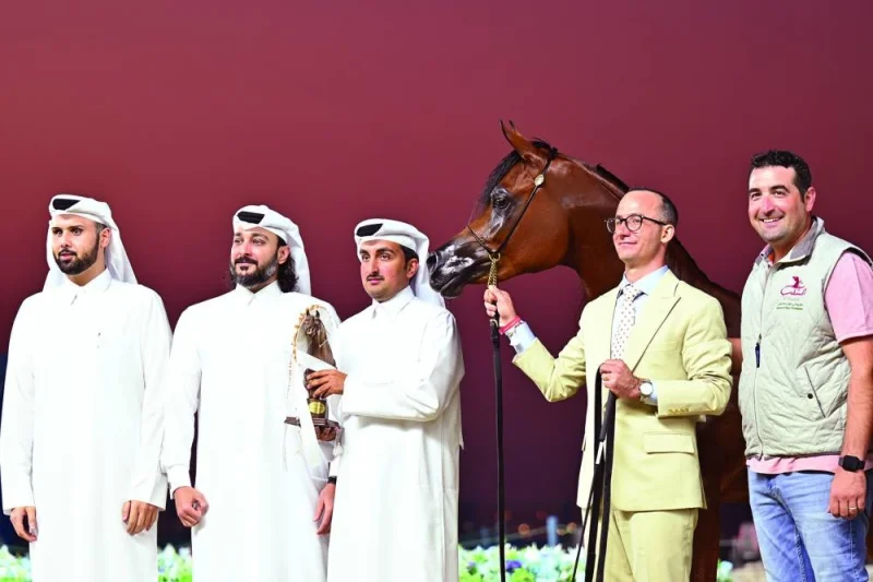 The connections of Shahbrys HVP celebrate with the trophy after the filly won the Class 1A of the Yearling Fillies Section at the World Arabian Horse Championship at the Old Doha Port.