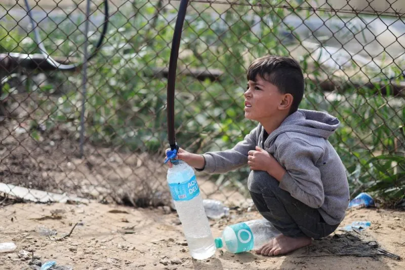 A Palestinian child collects water, during a water shortage in Rafah in the southern Gaza Strip, on Friday. REUTERS