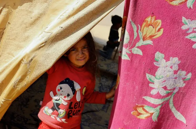 A child looks out of a tent, as displaced Palestinians, who fled their houses due to Israeli strikes, shelter in a tent camp near the border with Egypt, in Rafah in the southern Gaza Strip, on Monday. REUTERS