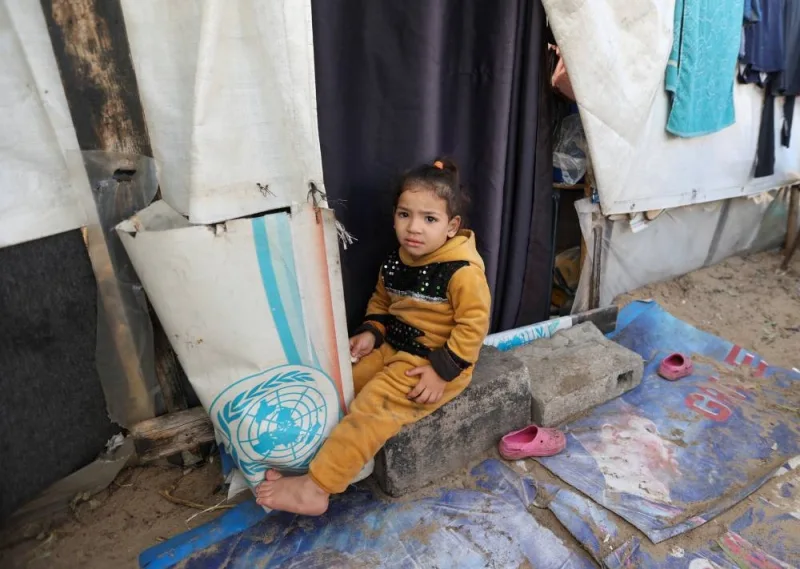 A displaced Palestinian girl, who fled her house due to Israeli strikes, shelters in a tent camp, in Khan Younis in the southern Gaza Strip, on Monday. REUTERS