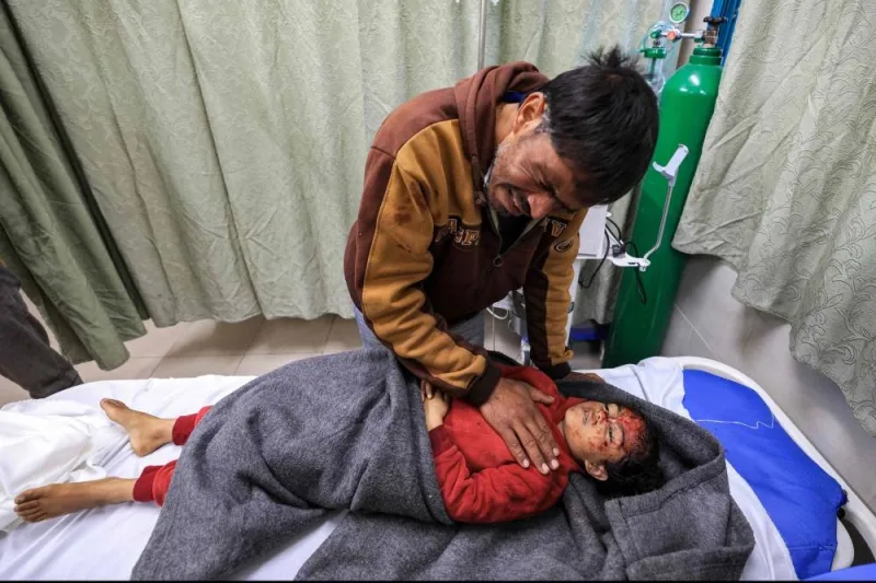 Hani Abu Jamea, a Palestinian from Khan Yunis, mourns over the body of his daughter Sidal, who died overnight while sleeping in a tent from a shrapnel fragment that hit her in the head following Israeli bombardment on a nearby position, at the Kuwaiti Hospital in Rafah in the southern Gaza Strip on Tuesday. AFP