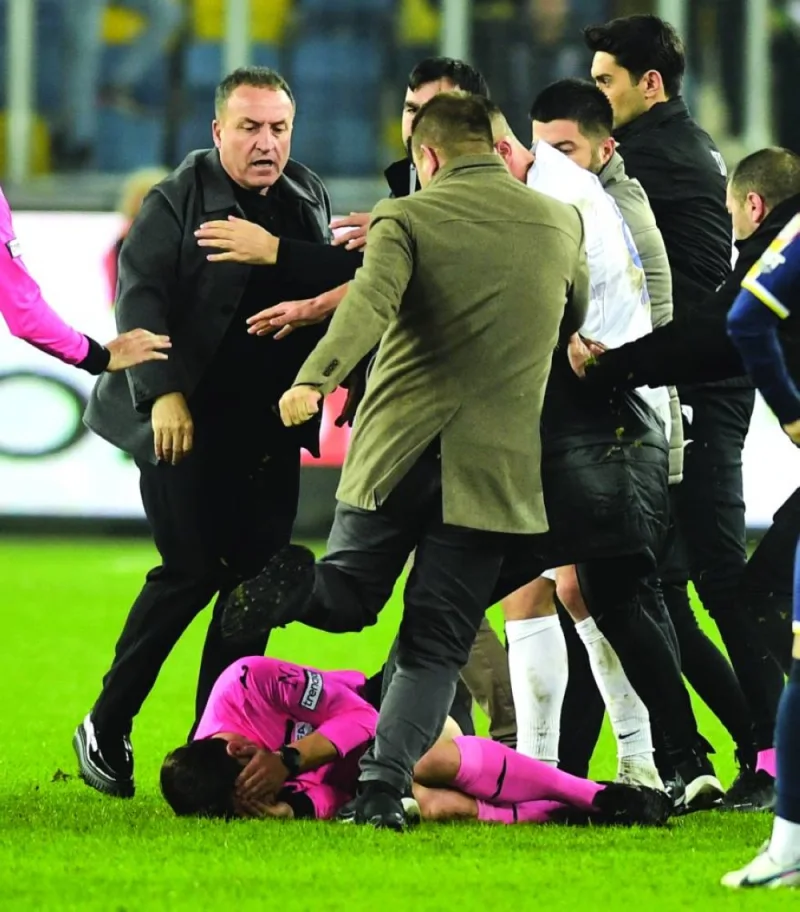 
Referee Halil Umut Meler lies on the pitch after Turkish side 
Ankaragucu’s president Faruk Koca (left) punched him in the face at the end of their Super Lig match against Rizespor on Monday. (Reuters)
 