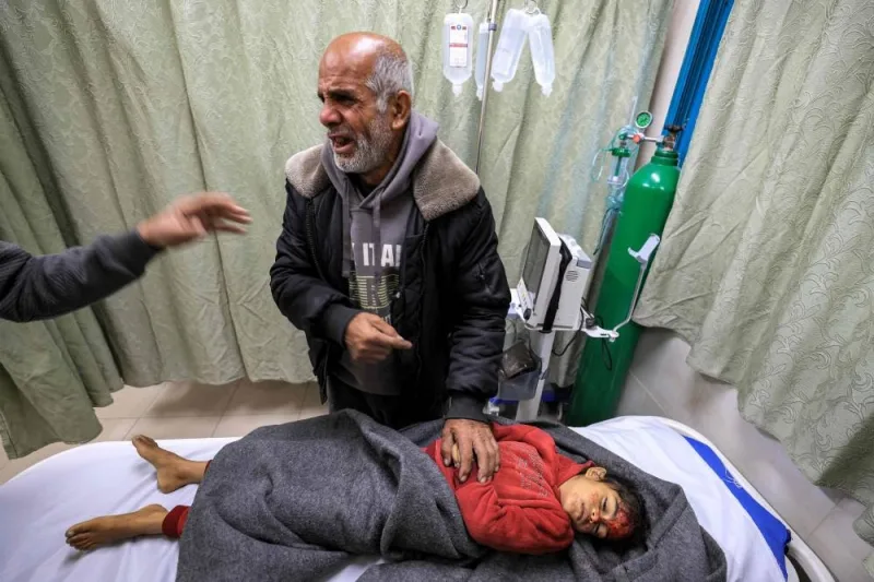 The grandfather of Sidal Abu Jamea, a Palestinian girl from Khan Yunis, mourns over her body after she died overnight while sleeping in a tent from a shrapnel fragment that hit her in the head following Israeli bombardment on a nearby position, at the Kuwaiti Hospital in Rafah in the southern Gaza Strip on Tuesday. AFP