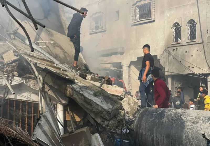 Palestinians inspect the site of an Israeli strike on a house, in Rafah in the southern Gaza Strip, on Thursday. REUTERS