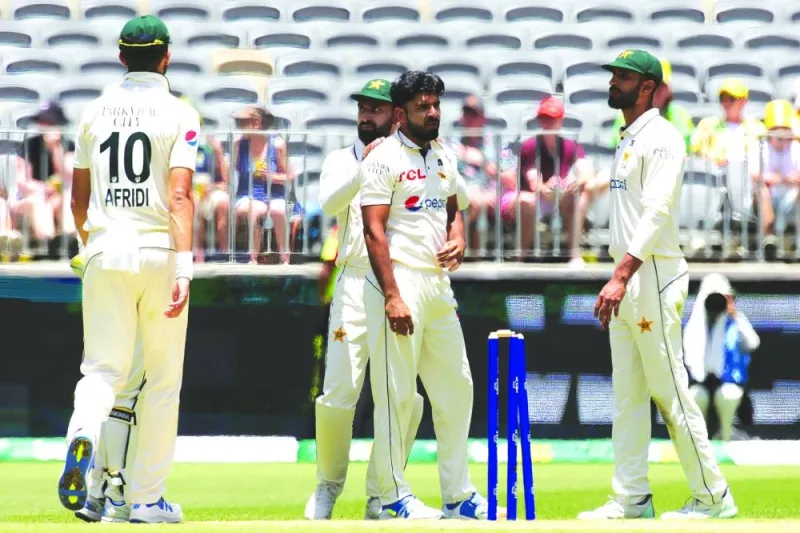 
Pakistan’s bowler Aamir Jamal (centre) is congratulated by teammates after taking the wicket of Australia’s Mitchell Starc on day two of the first Test in Perth yesterday. (AFP) 