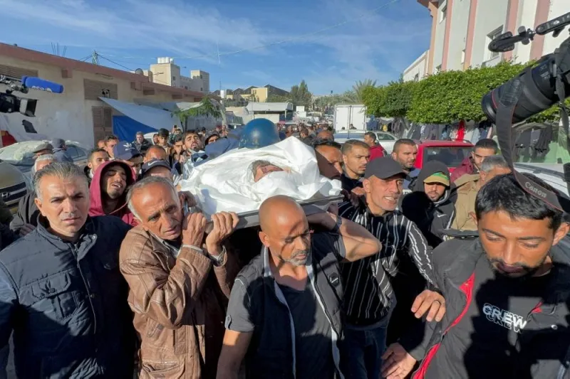 Palestinians carry the body of Al Jazeera cameraman Samer Abu Daqqa, who was killed by an Israeli drone strike on Friday while reporting on the earlier bombing of a school sheltering displaced people, as they attend his funeral in Khan Younis in the southern Gaza Strip, on Saturday. REUTERS