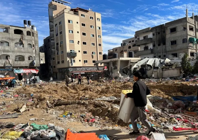 Palestinians inspect damages following an Israeli raid at Kamal Adwan hospital, in the northern Gaza Strip, on Saturday. REUTERS