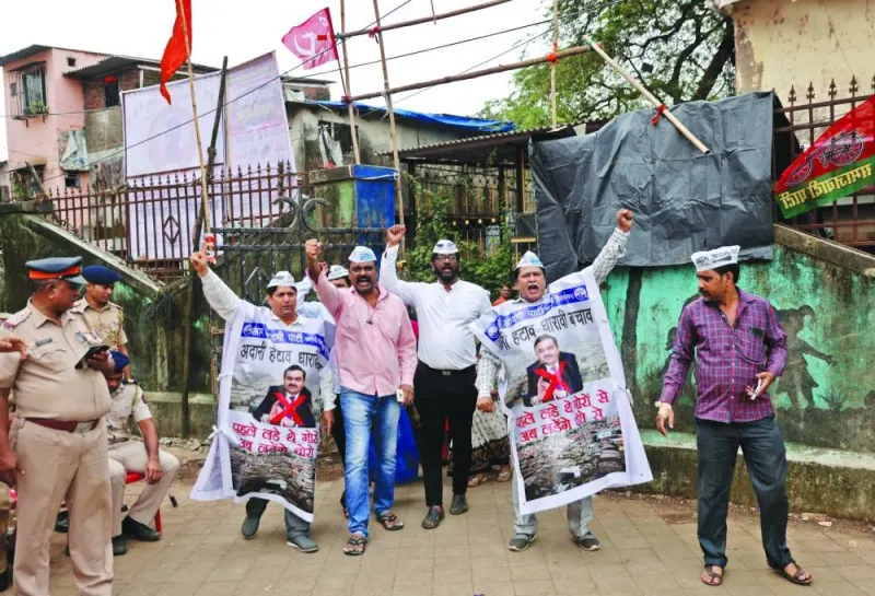 People shout slogans as they hold banners during a protest against the redevelopment of Dharavi, one of Asia&#039;s largest slums, by the Adani Group in Mumbai, India, in a file picture. Banners read: "Remove Adani, Save Dharavi" and "First we fought the whites now we fight the thieves". 