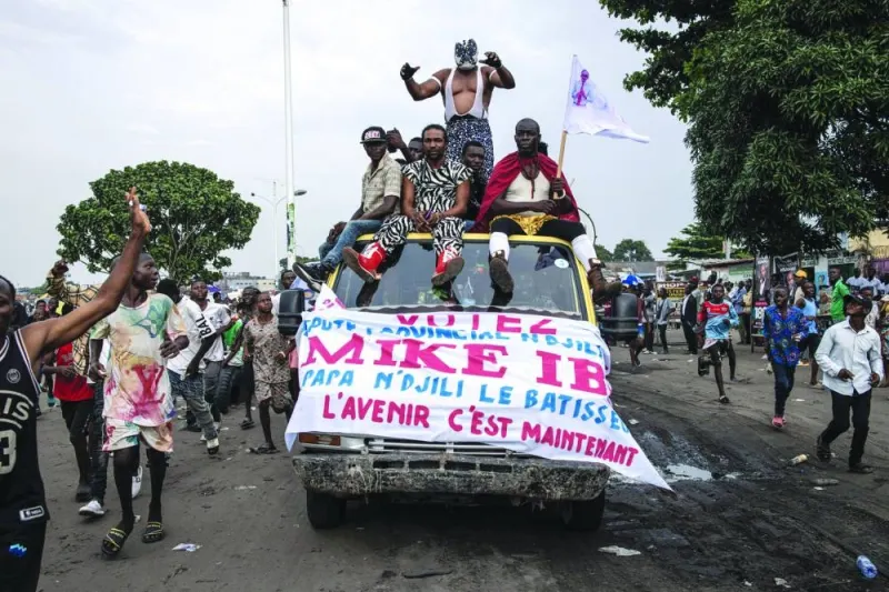 
A wrestler gestures as he stands on top of a car during opposition candidate Martin Fayulu’s final campaign rally in Kinshasa. 