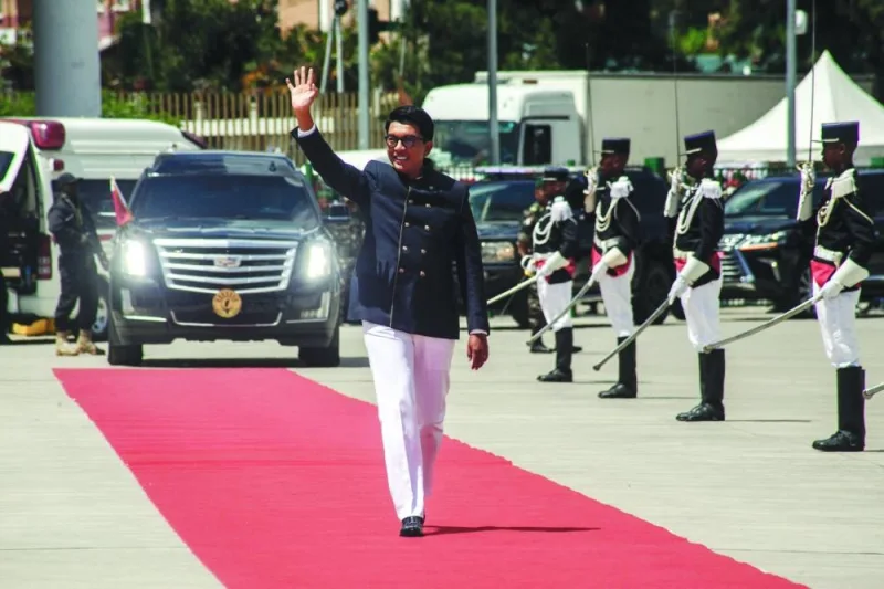 Re-elected Madagascar’s President Andry Rajoelina waves during his arrival to the presidential swearing-in ceremony in Antananarivo on Saturday.