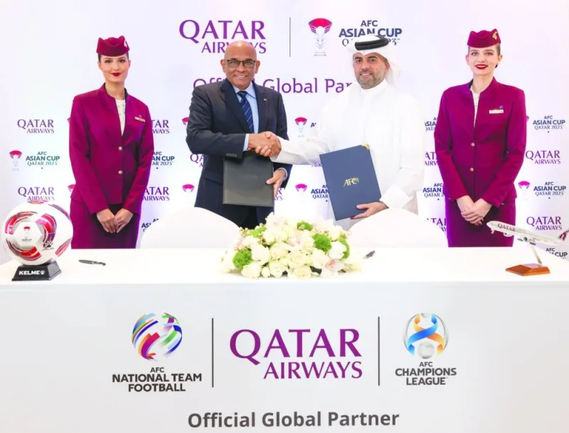 
Qatar Airways Group Chief Executive Officer Engineer Badr Mohamed 
al-Meer and AFC General Secretary Datuk Seri Windsor John pose after signing the sponsorship agreement. 