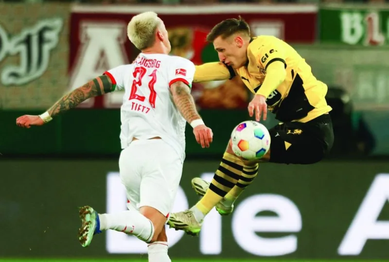 Augsburg’s Phillip Tietz (left) and Dortmund’s Nico Schlotterbeck vie for the ball during the Bundesliga match in Augsburg, Germany, on Saturday. (AFP)