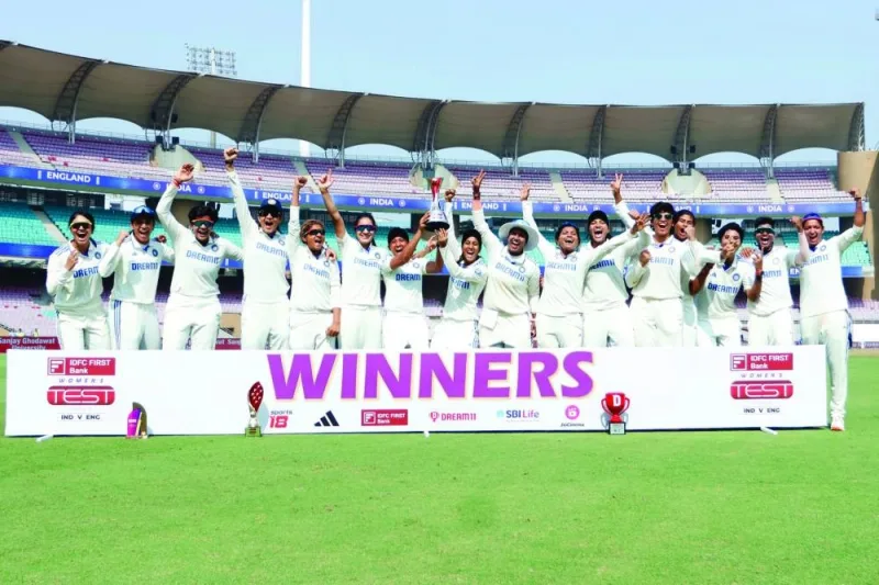 Indian players celebrate with the trophy after winning the one-off Test match for their first-ever win at home against England in Mumbai on Saturday.