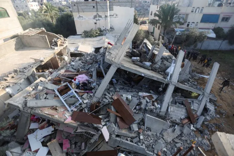 Palestinians inspect the site of an Israeli strike on a house in Rafah in the southern Gaza Strip, on Sunday. REUTERS