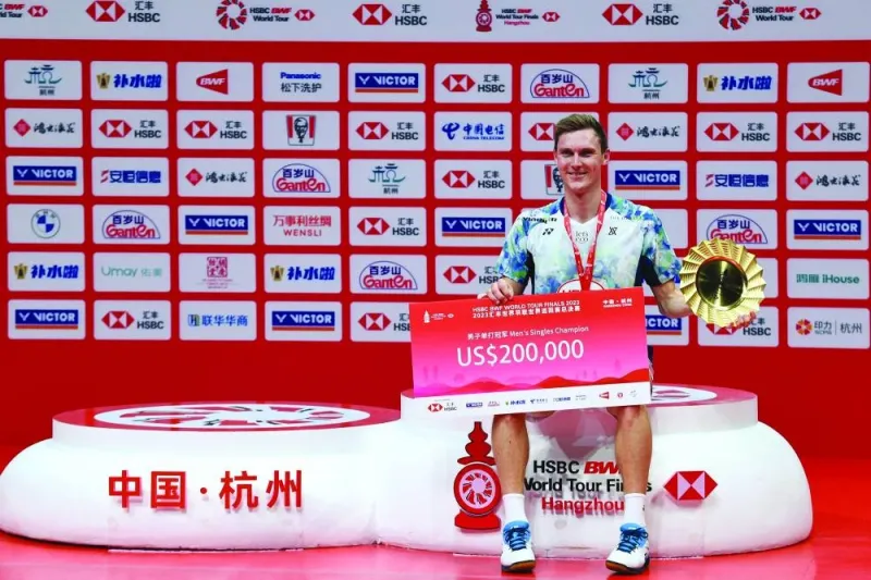 
Denmark’s Viktor Axelsen poses with the trophy after his win against China’s Shi Yuqi after the singles final during the BWF Badminton World Tour Finals award ceremony in Hangzhou, in China’s eastern Zhejiang province yesterday. (AFP) 