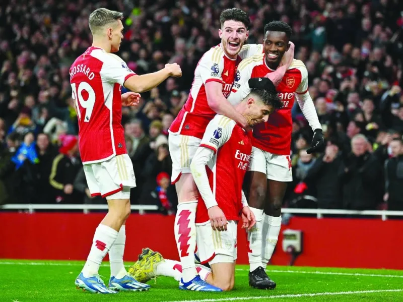 
Arsenal’s Kai Havertz (centre) is mobbed by teammates Leandro Trossard (left) and Declan Rice (second left) and Eddie Nketiah after scoring the team’s second goal against Brighton and Hove Albion at the Emirates Stadium in London yesterday. (AFP) 