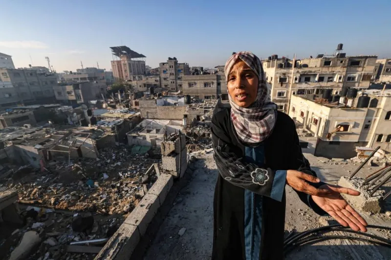 A woman shows the destruction on her house and nearby area in Rafah in the southern Gaza Strip, on Monday. AFP