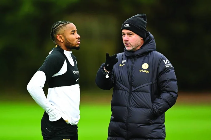 Chelsea manager Mauricio Pochettino (right) speaks to forward Christopher Nkunku at a training session in London on Monday.