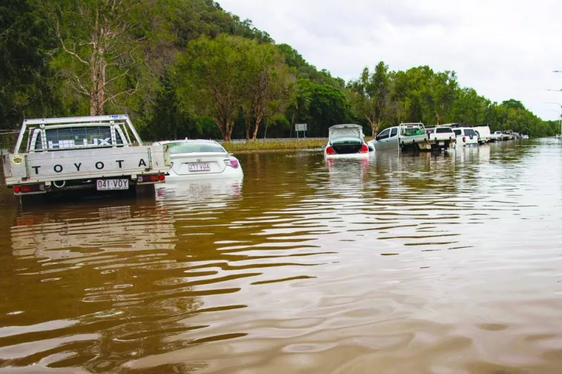 Cars stand amid floodwaters at Cairns Airport in Cairns on Monday.