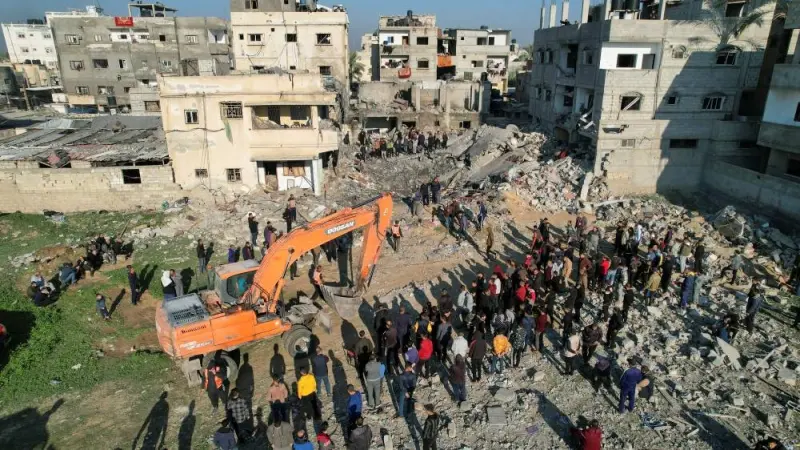 Palestinians gather at the site of an Israeli strike on a house, in Rafah in the southern Gaza Strip, on Tuesday. REUTERS