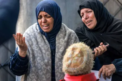 Women mourn the loss of loved ones who were killed overnight during Israeli bombardment, at a hospital in Rafah in the southern Gaza Strip, on Tuesday. AFP