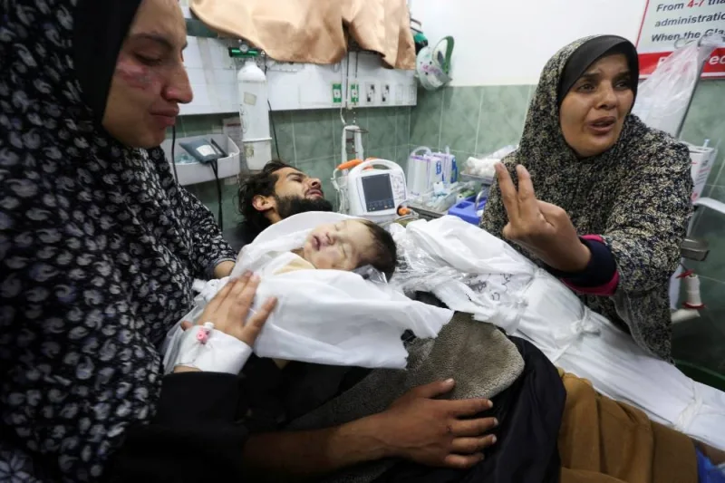 Suzan Zourob, the grandmother of two Palestinian children, a newborn Al-Amera Ayesha and a young boy Ahmed Zourob, who were killed in an Israeli strike, mourns next to the children&#039;s wounded father and mother, in Rafah, in the southern Gaza Strip, on Tuesday. REUTERS