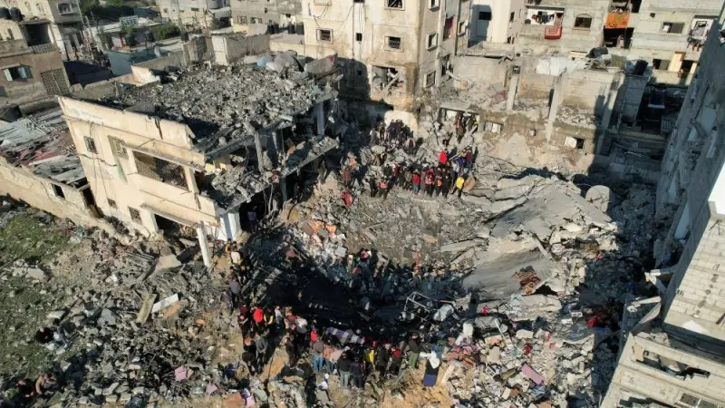 Palestinians gather at the site of an Israeli strike on a house in Rafah in the southern Gaza Strip, on Tuesday. REUTERS