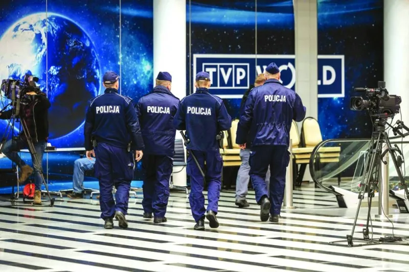 
A group of police officers are seen entering the headquarters of Polish Public TV in Warsaw on Tuesday. (AFP) 