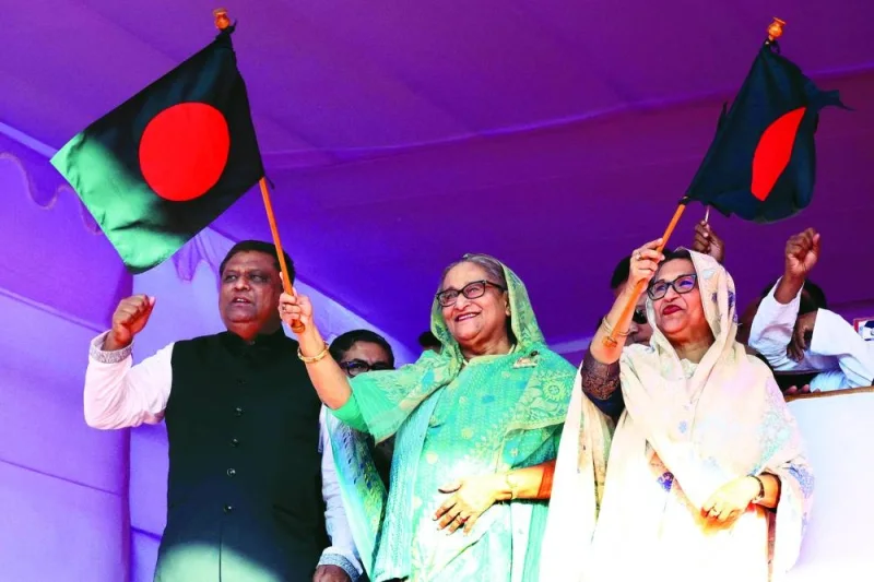 Bangladesh’s Prime Minister Sheikh Hasina waves the Bangladeshi flag as she kicks off the campaign ahead of the general election in Sylhet, Bangladesh, on Wednesday.
