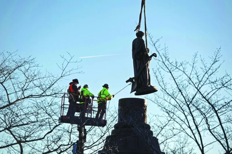 In this photo released by Arlington National Cemetery, workers remove the Confederate Memorial statue at the cemetery in Arlington, Virginia, on Wednesday.