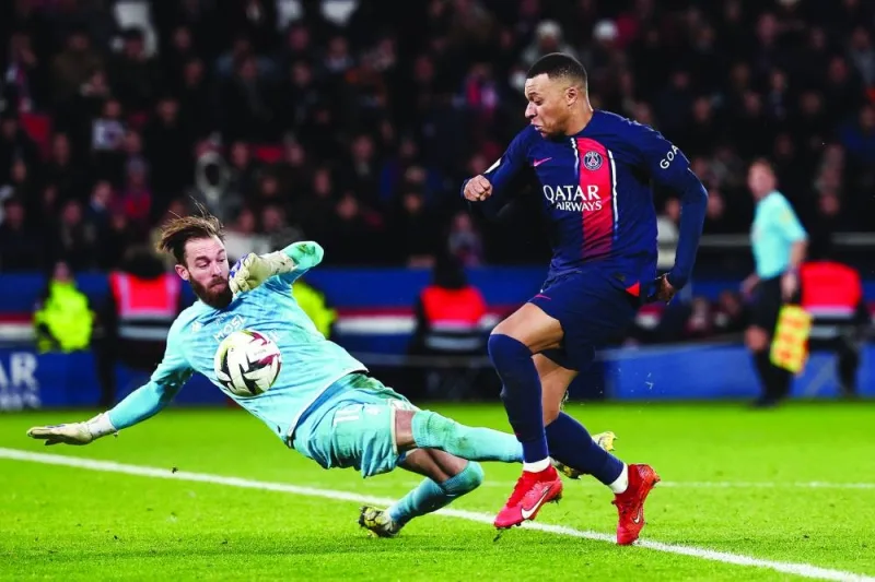 Paris Saint-Germain’s Kylian Mbappe scores past Metz’s goalkeeper Alexandre Oukidja during the Ligue 1 match in Paris on Wednesday.
