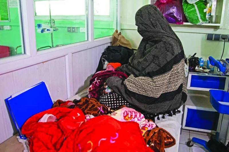 
In this photograph taken on December 8, Islam Bibi, mother of six children and newborn triplets, sits beside her three babies at the Doctors Without Borders (MSF)-run maternity hospital in Khost. 
