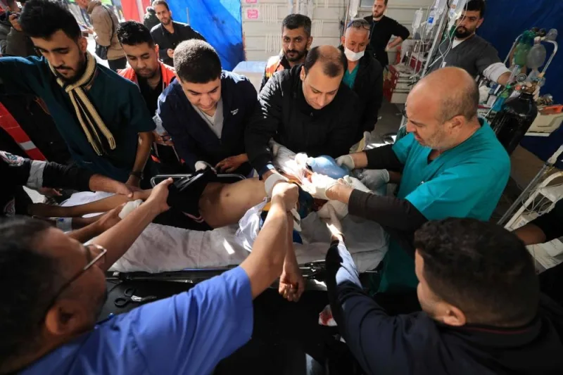 Palestinian medics care for an injured youth following Israeli bombardment, at the Kuwaiti Hospital in Rafah in the southern Gaza Strip, on Friday. AFP