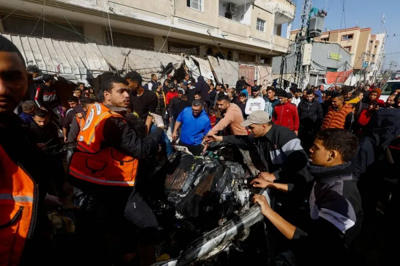 Palestinians inspect the site of an Israeli strike on a car in Rafah, southern Gaza Strip, on Friday. REUTERS