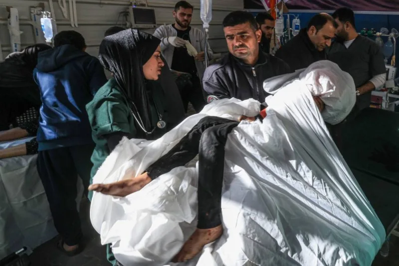 Palestinian medics transport a victim following Israeli bombardment, at the Kuwaiti Hospital in Rafah in the southern Gaza Strip, on Friday. AFP