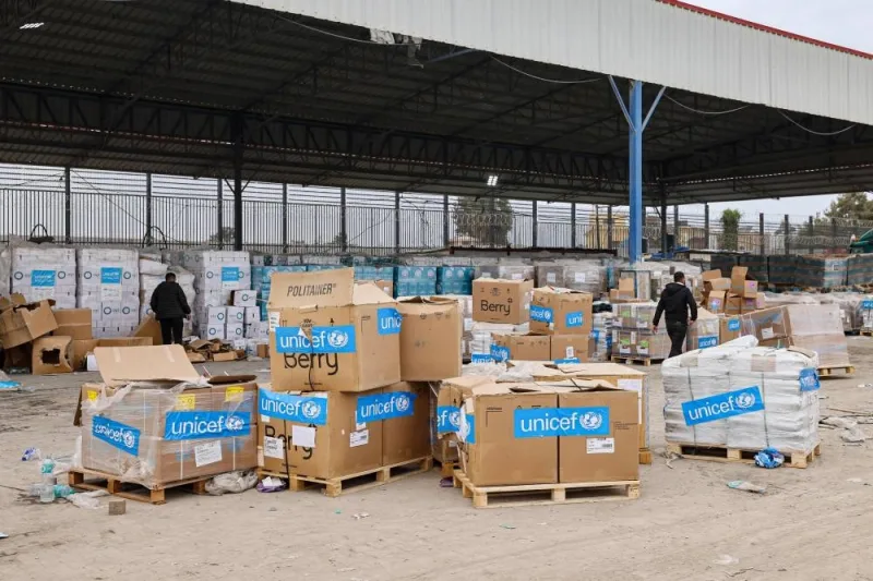 Boxes containing humanitarian aid are unloaded at the Karm Abu Salem (Kerem Shalom) crossing in Rafah in the southern Gaza Strip, on Thursday. AFP