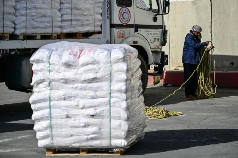 A truck driver unloads his humanitarian aid cargo for inspection upon arriving from Egypt on the Israeli side of the Kerem Shalom border crossing with the southern Gaza Strip on Friday. AFP
