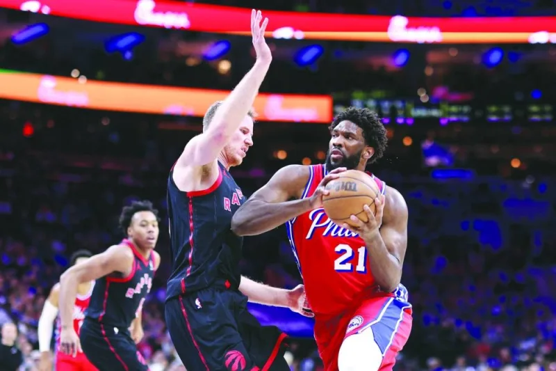 
Joel Embiid of the Philadelphia 76ers drives as Jakob Poeltl of the Toronto Raptors guards during the third quarter of their NBA game at the Wells Fargo Center in Philadelphia, Pennsylvania. (AFP) 