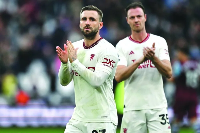 
Manchester United’s Luke Shaw (left) and Jonny Evans applaud fans after their loss to West Ham in the Premier League at the London Stadium on Saturday. (AFP)  
