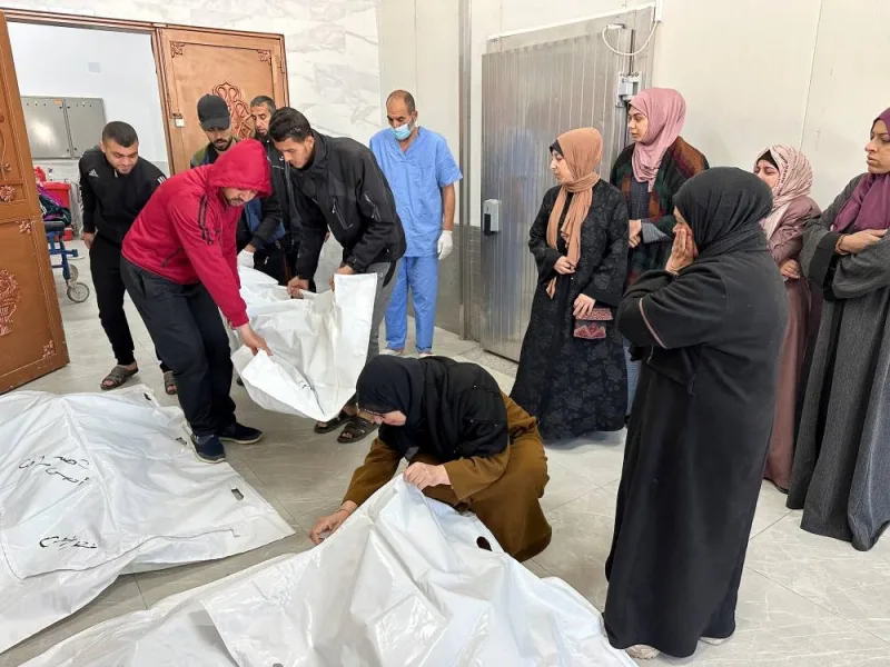 Palestinian mourners react next to the bodies of their relatives from the Shaat family, who were killed in an Israeli strike, at a hospital in Khan Younis in the southern Gaza Strip, on Tuesday. REUTERS