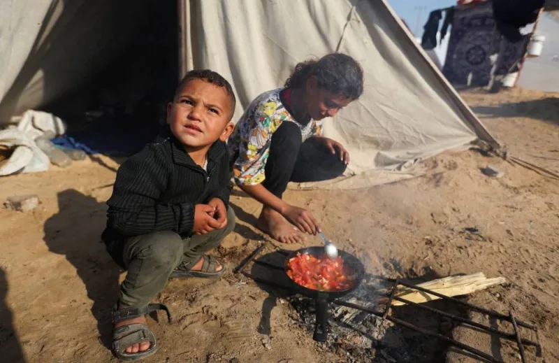 Displaced Palestinians, who fled their houses due to Israeli strikes, shelter in a tent camp, in Rafah in the southern Gaza Strip, on Tuesday. REUTERS