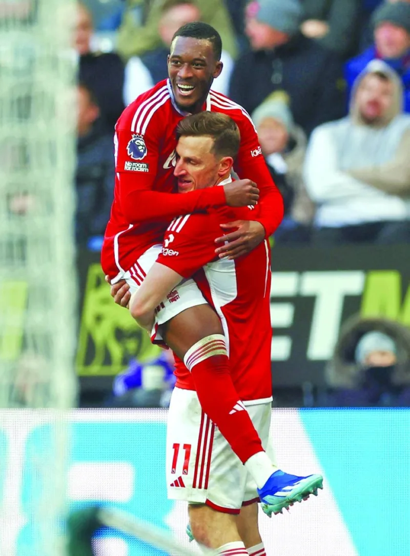 Nottingham Forest’s Chris Wood (right) celebrates with Callum Hudson-Odoi after scoring a goal against Newcastle United on Tuesday. (Reuters)